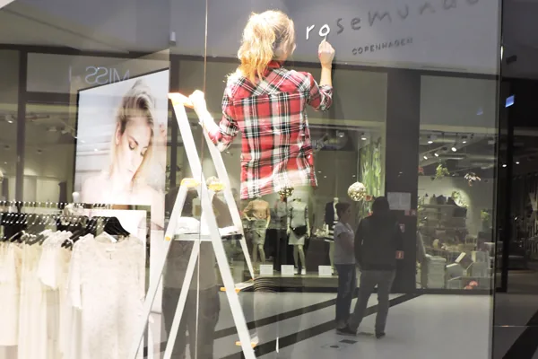 Shop owner styling a store window during an Upgrade Stores workshop